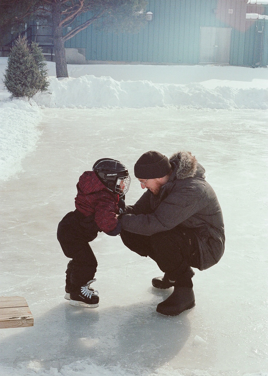 child and adult on the ice